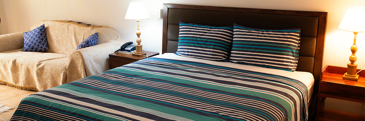 A hotel room including a large bed and sofa